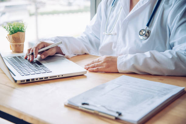 istock The doctor is sitting worker on laptop 994060816