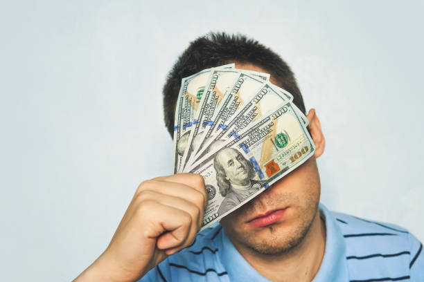 istock Businessman with dollar banknote taped to eyes 994069236