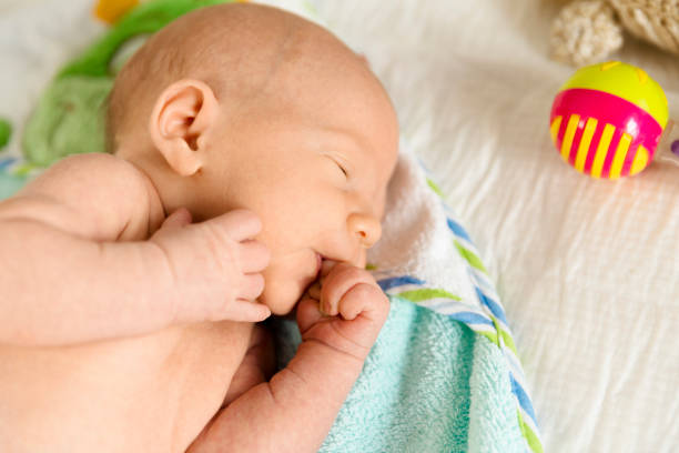 istock Cute newborn baby boy sleeps in a nursery while changing diapers 994069354
