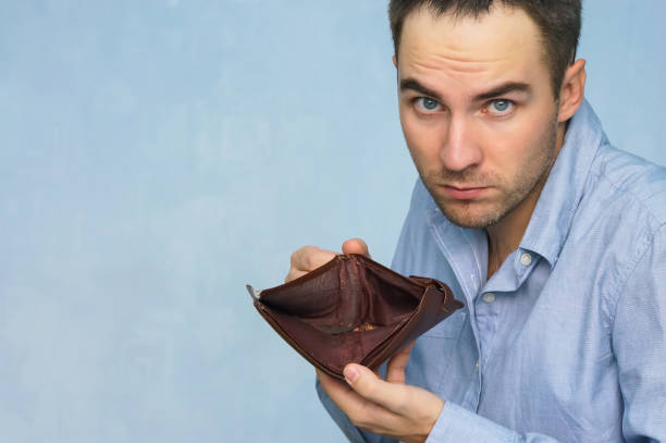 istock Bankruptcy - Business Person holding an empty wallet 994069656