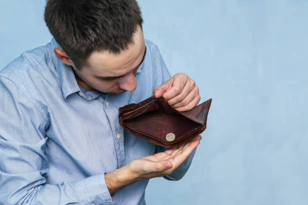 istock The guy pulls out the last ruble out of an empty purse. 994069766