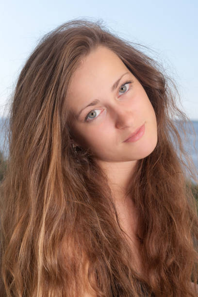 High school student. Sad blue-eyed teen girl looks at the camera.