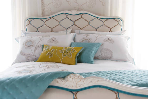 istock Beautiful bed with colorful pillows 994076974