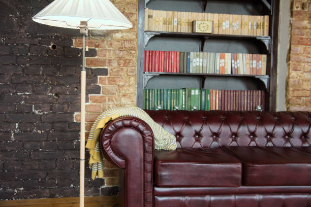 istock Interior of the room in old style with a leather sofa 994077302