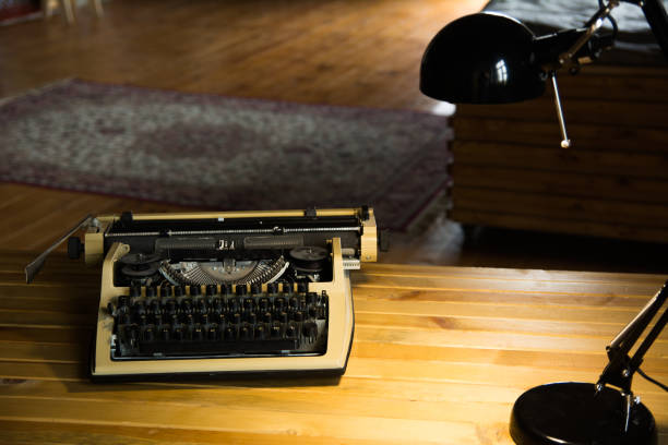 istock An old typewriter and a lamp on a wooden lacquered table and a room 994077330