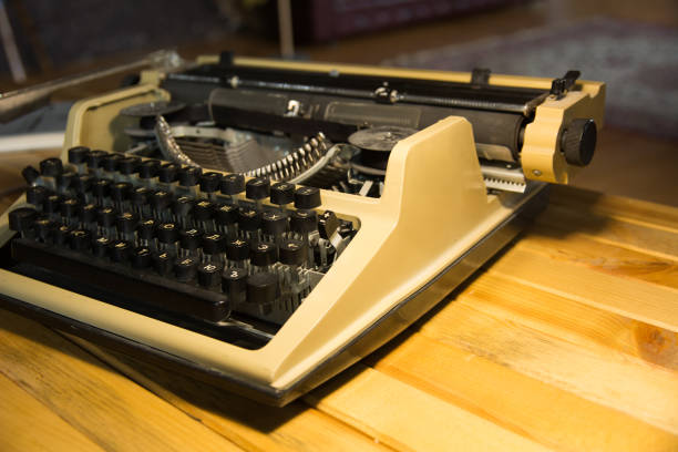istock An old typewriter illuminated by a lamp on a wooden lacquered table 994077340