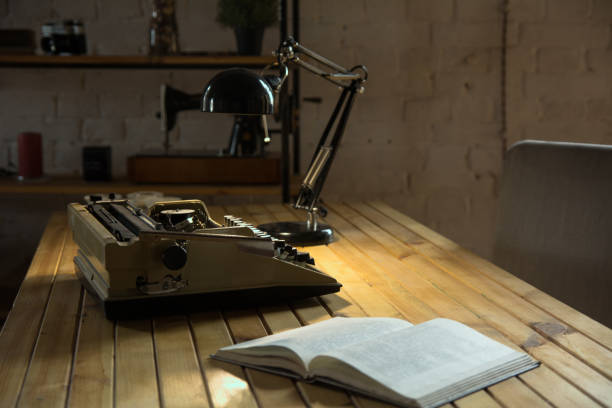 istock An old typewriter illuminated by a lamp on a wooden lacquered table 994077364