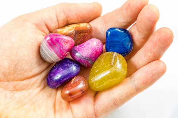 istock Several Beautiful Colorful Crystals in a Hand 994087394