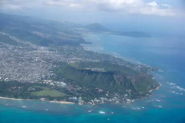 Aerial view of Diamondhead, Kapiolani Park, Waikiki, Natatorium, Kapahulu town, Pacific ocean, clouds, and on Oahu, Hawaii.