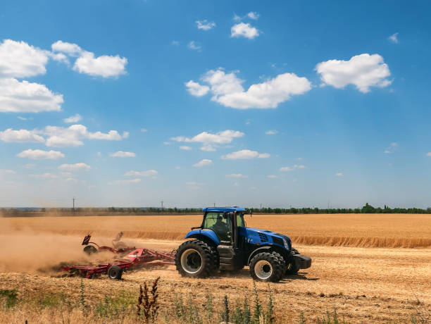 istock Tractor in the field harvests. 994098702