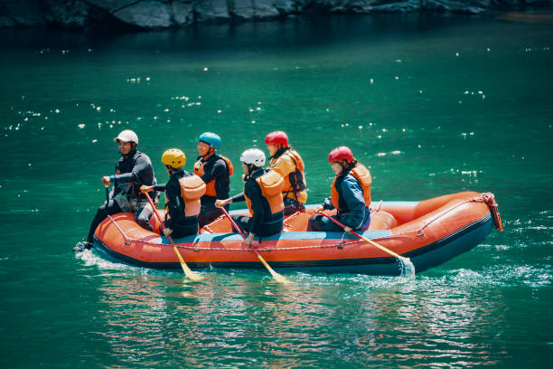 istock Group of men and women in a raft on a river 994098730