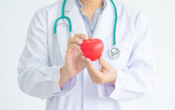 istock Doctor with hanged stethocope is holding red rubber heart shape 994099142