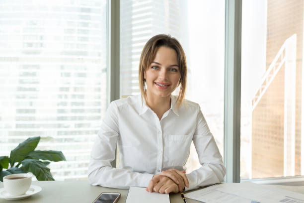 Successful businesswoman talking at camera giving interview or recording vlog