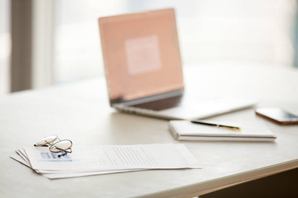 istock Office table with laptop, documents and glasses for reading concept 994101938