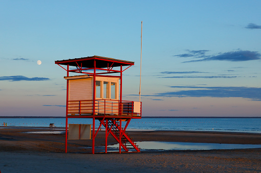 Sunset at Pärnu beach. Illuminated lifesaver station.