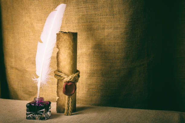 istock Literature concept. Old inkstand with feather near scroll and on canvas background 994104836