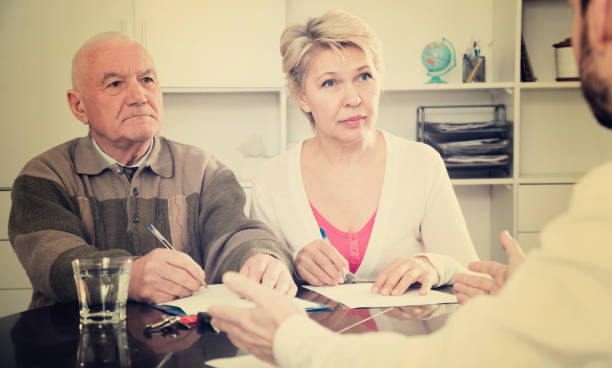 istock couple signing papers in bank 994112610