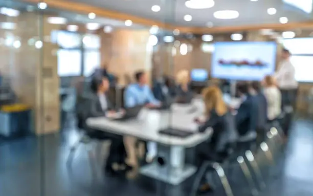 Photo of Soft focus business people sitting in conference room