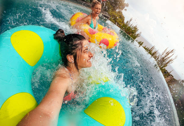 istock Friends having fun on inflatable rings in the pool 994122292