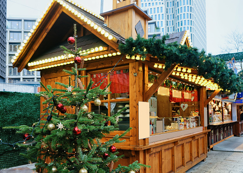 Stand with sweets at Christmas Market at Kaiser Wilhelm Memorial Church in Winter Berlin, Germany. Advent Fair Decoration and Stalls with Crafts Items on the Bazaar.