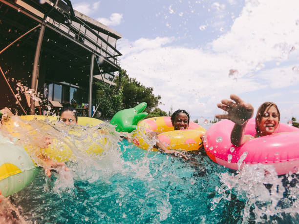 istock Friends having fun on floaties in swimming pool 994124958