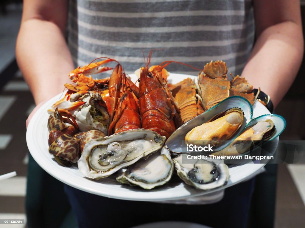 Plate of steamed crayfish, giant river prawn, mussel, giant crab and fresh oyster. Plate of steamed crayfish, giant river prawn, mussel, giant crab and fresh oyster. Seafood buffet line. Seafood Stock Photo