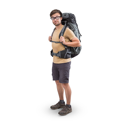 Young hiker with a large backpack in shorts and t-shirt.