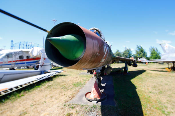 Abandoned Ilyushin Il-28 jet bomber, photographed in the middle of a field at an old abandoned military base, surrounded by tall grass and trees close to Bucharest international airport.