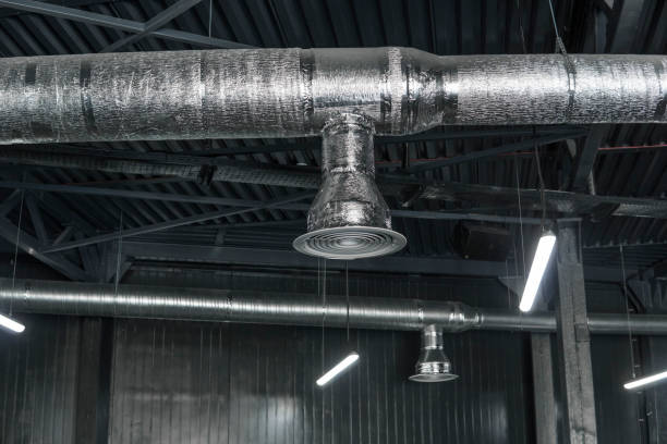 istock Ventilation system on the ceiling of large buildings. Ventilation pipes in silver insulation material hanging from the ceiling inside new building. 994144348