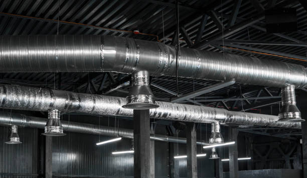 istock Ventilation system on the ceiling of large buildings. Ventilation pipes in silver insulation material hanging from the ceiling inside new building. 994145376