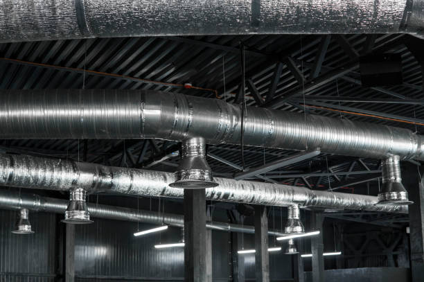 istock Ventilation system on the ceiling of large buildings. Ventilation pipes in silver insulation material hanging from the ceiling inside new building. 994147044