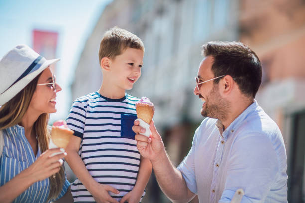 istock Happy family having fun outdoor after shopping, eating ice cream 994148564