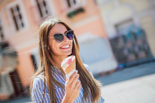 Happy girl enjoying ice cream outdoors