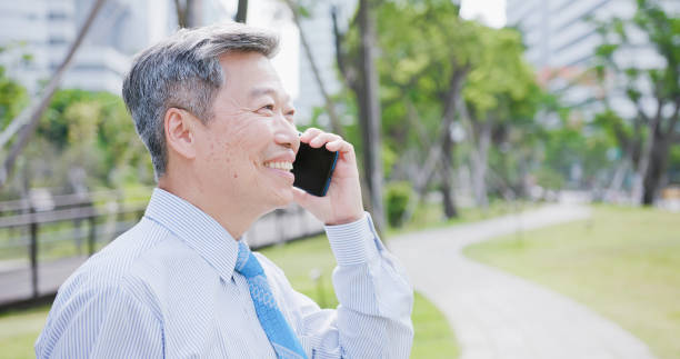 istock old businessman speak phone 994151552