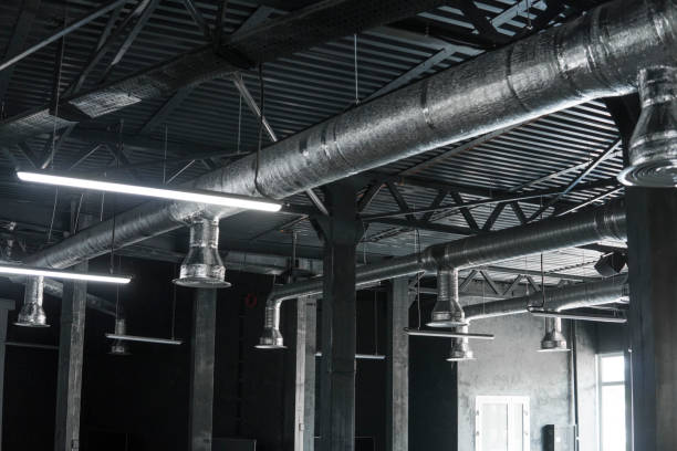 istock Ventilation system on the ceiling of large buildings. Ventilation pipes in silver insulation material hanging from the ceiling inside new building. 994151694