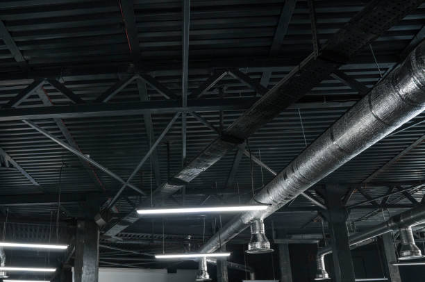 istock Ventilation system on the ceiling of large buildings. Ventilation pipes in silver insulation material hanging from the ceiling inside new building. 994151734