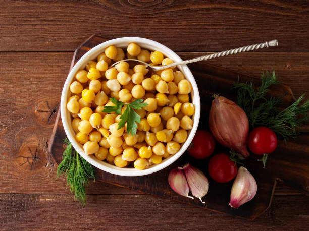 Cooked Chickpeas on bowl on dark wooden table. Healthy, vegetarian nutritious protein food of Middle East. Top view. stock photo