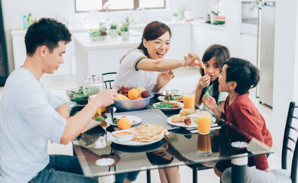 istock Mother, father and two children eating together 994158510