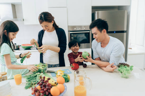 istock Cheerful family preparing lunch together 994158526