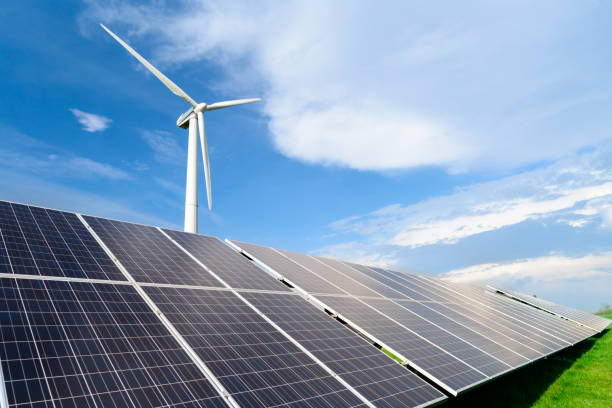istock Solar energy panels and windmills against blue sky on summer day 994158748
