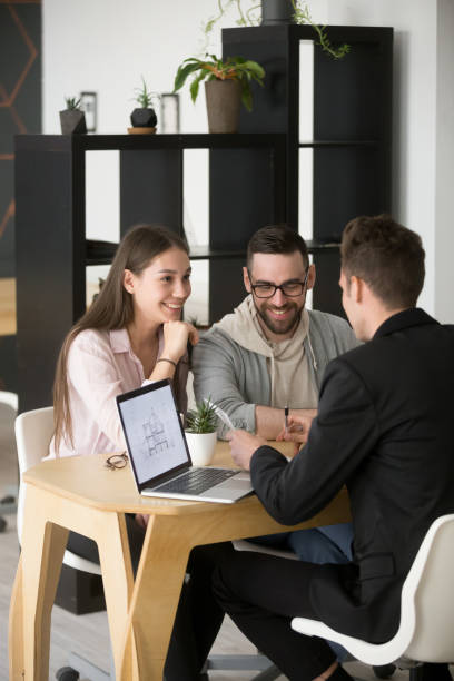 architect discussing house project with millennial buyers couple - business vertical talking usa imagens e fotografias de stock