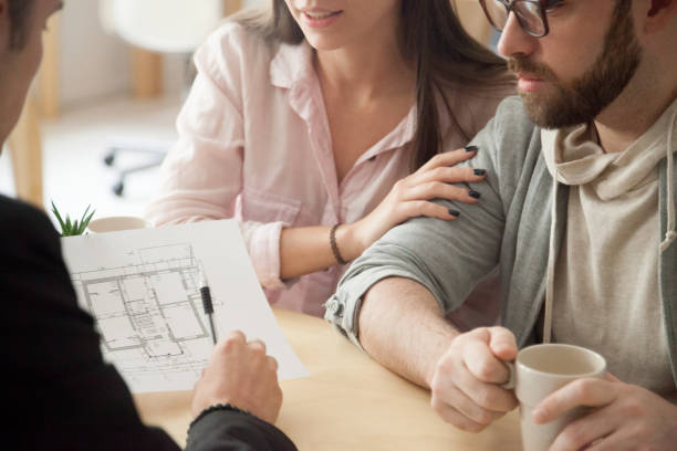Millennial couple consulting about home design project in architect office