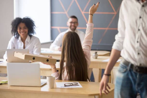 istock Female employee asking colleagues have dinnertime together 994164892