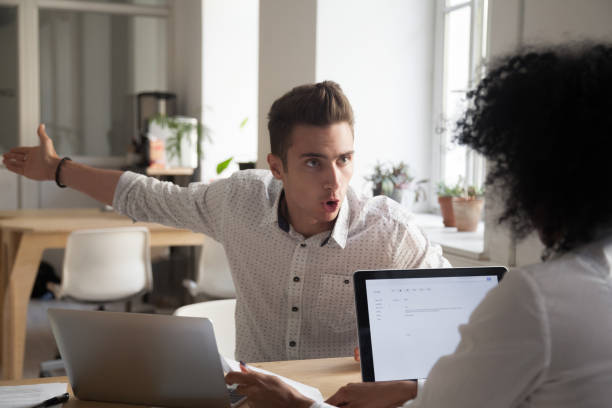 Mad male employee blaming female colleague for mistake Mad male worker yelling at female colleague asking her to leave office, multiracial coworkers disputing during business negotiations, employees cannot reach agreement, blaming for mistake or crisis rudeness stock pictures, royalty-free photos & images