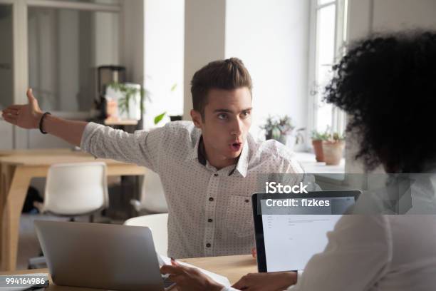 Mad Male Employee Blaming Female Colleague For Mistake Stock Photo - Download Image Now