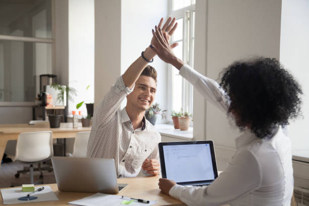 istock Happy colleagues giving high five satisfied with high results 994164990