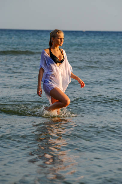istock Beautiful women run by the sea 994172500