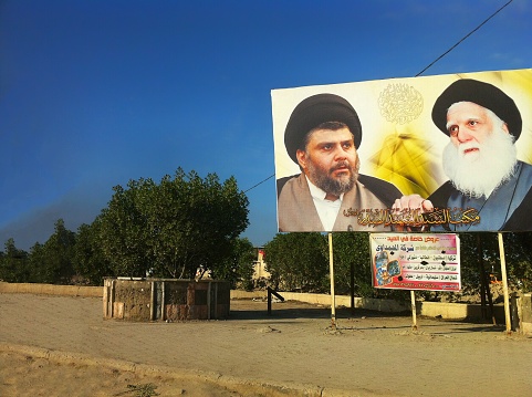 Basra, Iraq - December 18, 2012: Billboard for political propaganda of Muqtada al-Sadr who is an Iraqi Shiite cleric and politician considered to be one of the most powerful political figure in Iraq.