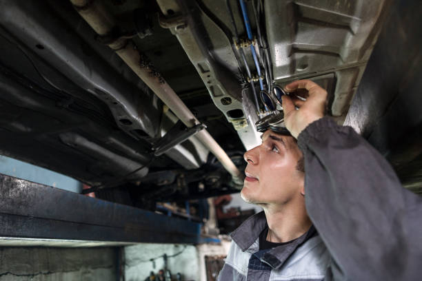 istock Mechanic checking bottom of a car 994175606