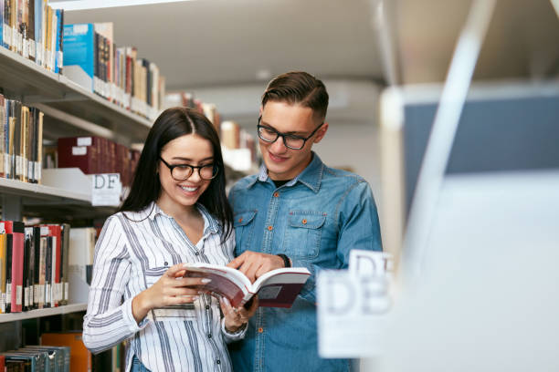 istock Couple Of Students In College Library 994185260